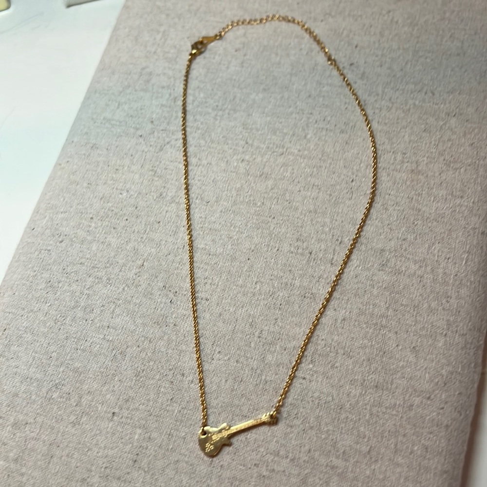 NWOT gold necklace with guitar